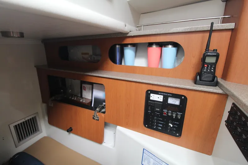 Slide: The Image of Interior of 2007 Sailfish 3006 WALKAROUND boat with control panel and storage. - 21