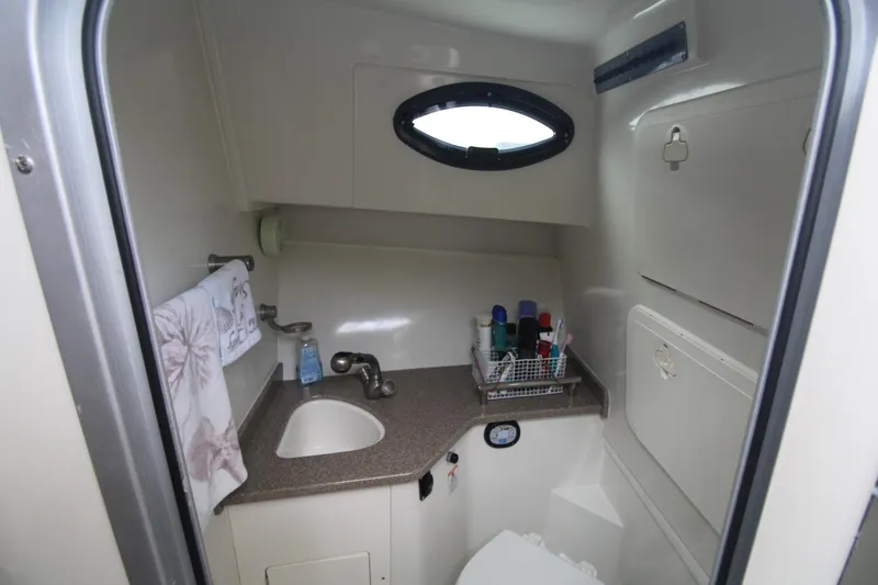 Slide: The Image of 2007 Sailfish 3006 WALKAROUND boat bathroom with sink, storage, and toiletries. - 24
