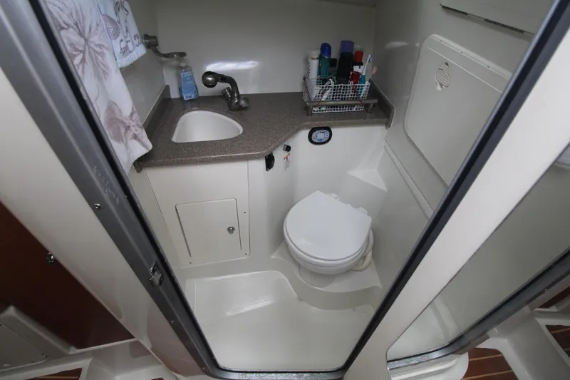 Slide: The Image of 2007 Sailfish 3006 WALKAROUND boat bathroom with sink, toilet, and storage. - 25
