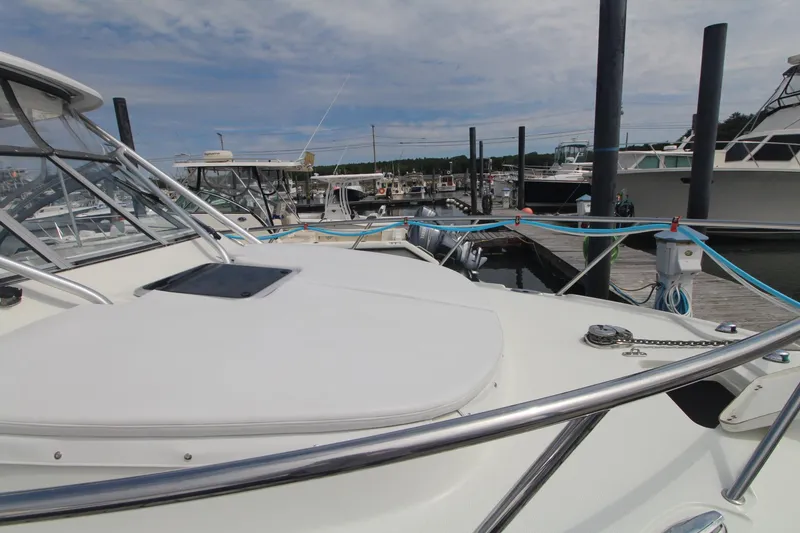 Slide: The Image of 2007 Sailfish 3006 WALKAROUND boat docked at marina under cloudy sky. - 3