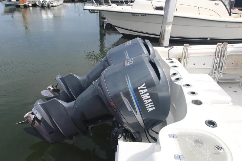 Slide: The Image of Twin Yamaha outboard motors on a 2007 Sailfish 3006 WALKAROUND boat at a marina. - 5
