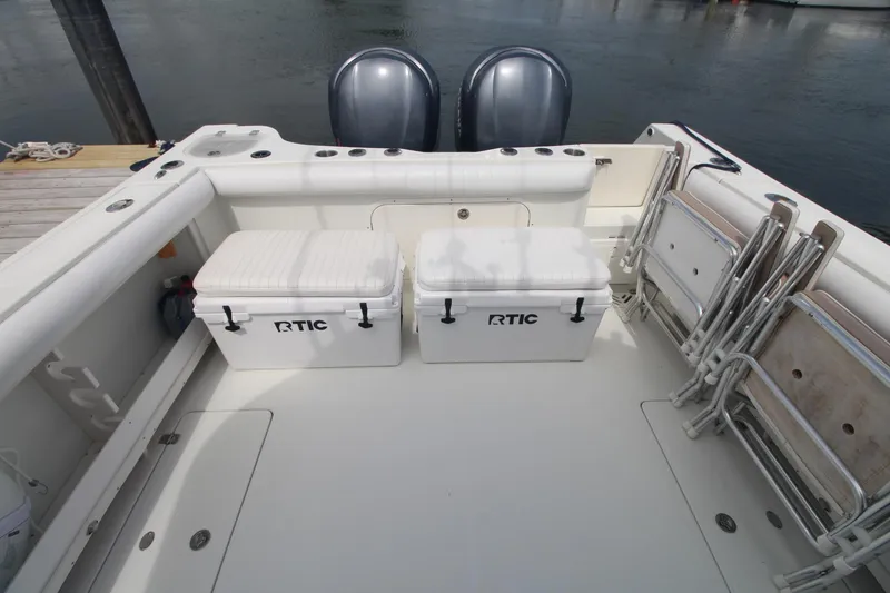 Slide: The Image of 2007 Sailfish 3006 WALKAROUND boat deck with RTIC coolers and foldable chairs. - 7