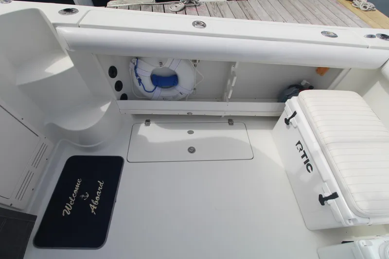 Slide: The Image of 2007 Sailfish 3006 WALKAROUND boat deck with cooler, life preserver, and welcome mat. - 8