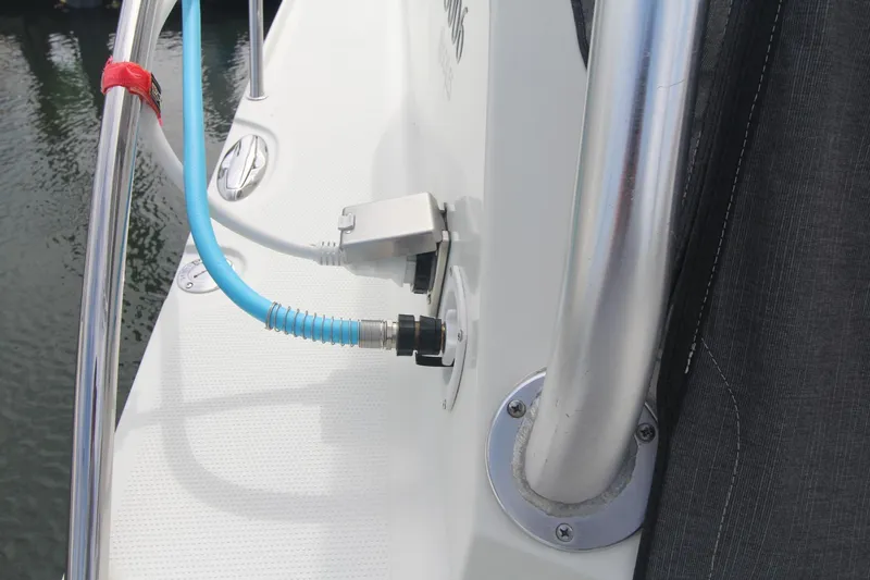 Slide: The Image of 2007 Sailfish 3006 WALKAROUND boat deck with hose connection and railing. - 9