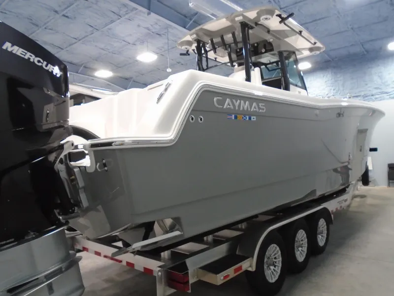 Slide: The Image of 2026 Caymas 34 CT boat on trailer in indoor showroom. - 10