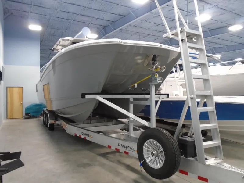 Slide: The Image of 2026 Caymas 34 CT boat on trailer in indoor storage facility. - 11
