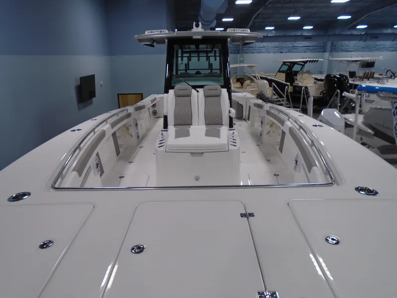 Slide: The Image of 2026 Caymas 34 CT boat interior with seating and sleek design in showroom. - 12