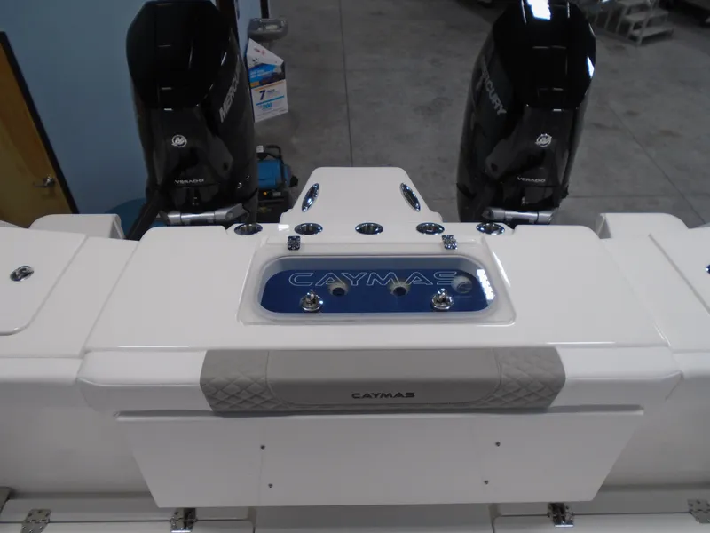 Slide: The Image of 2026 Caymas 34 CT boat with dual Mercury engines in a showroom. - 17
