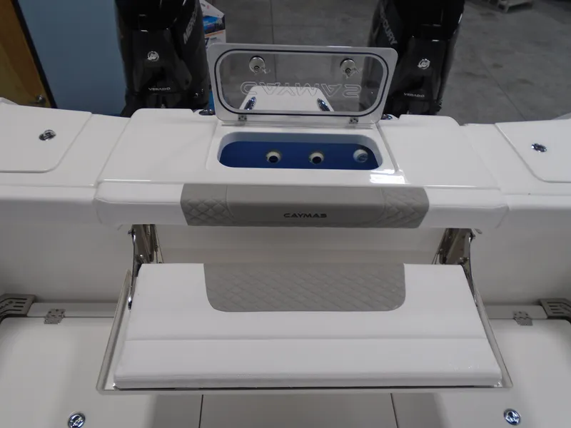 Slide: The Image of 2026 Caymas 34 CT boat with open storage compartment and visible engine parts. - 18