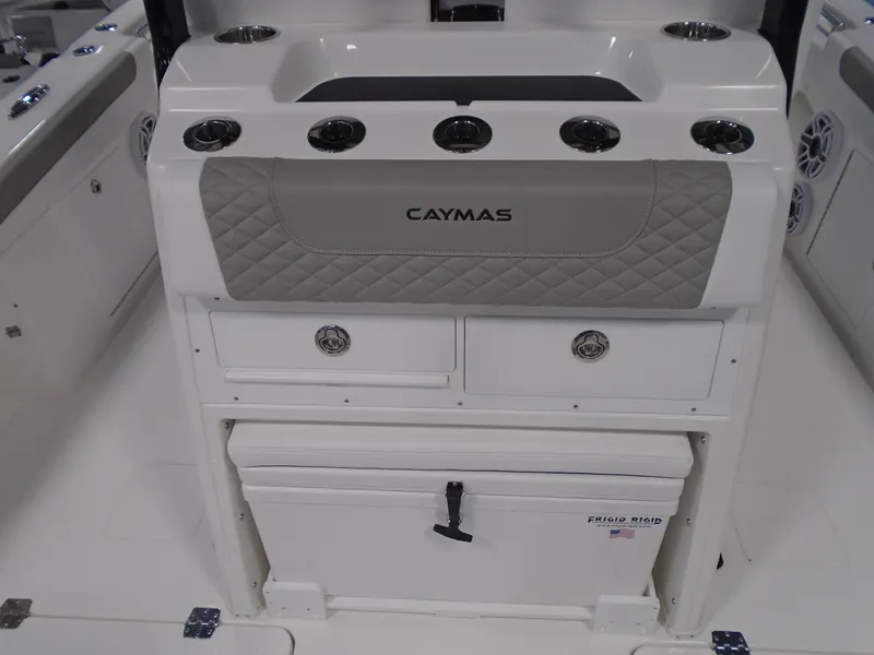 Slide: The Image of 2026 Caymas 34 CT boat interior with storage compartments and cup holders. - 23