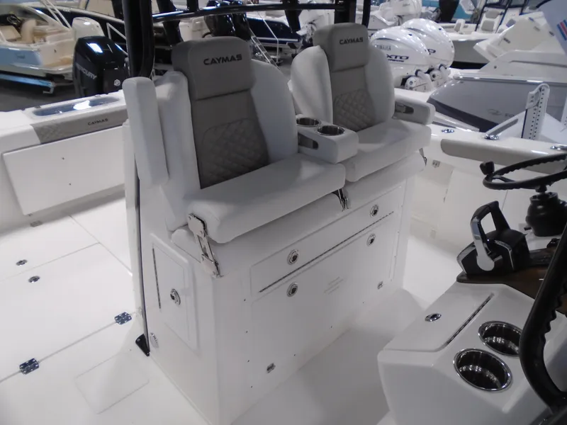 Slide: The Image of 2026 Caymas 34 CT boat interior with dual cushioned seats and cup holders. - 27