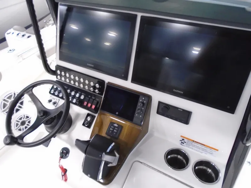 Slide: The Image of Helm of 2026 Caymas 34 CT boat with dual Garmin displays and control panel. - 29
