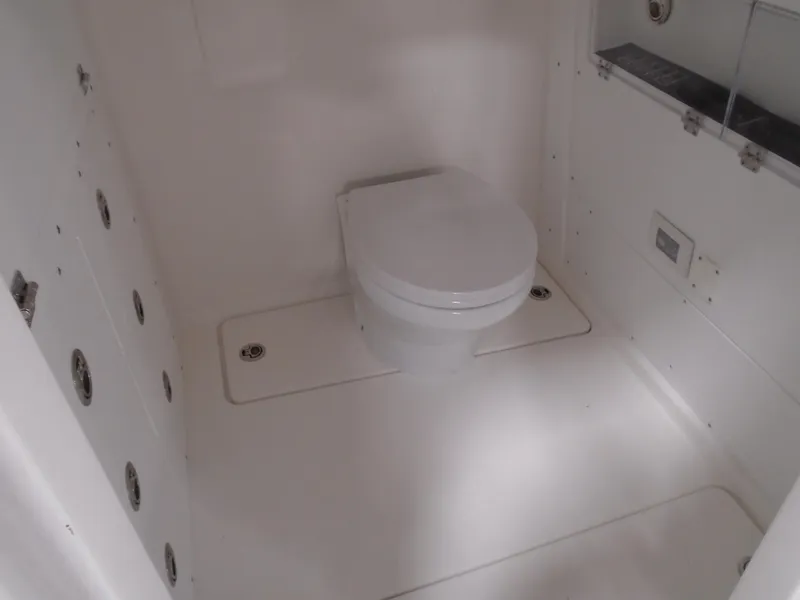 Slide: The Image of 2026 Caymas 34 CT boat bathroom with modern white toilet and sleek design. - 34