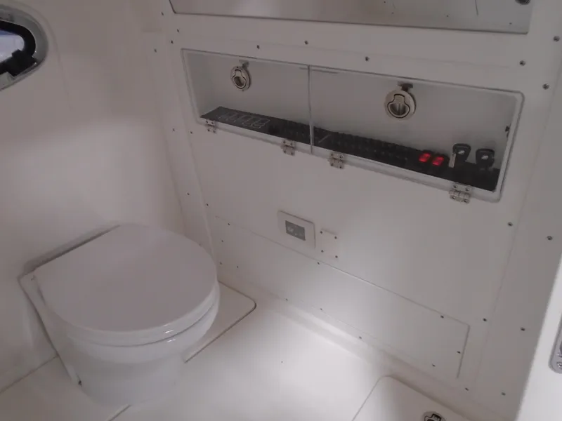 Slide: The Image of Interior of 2026 Caymas 34 CT boat featuring a compact bathroom setup. - 35