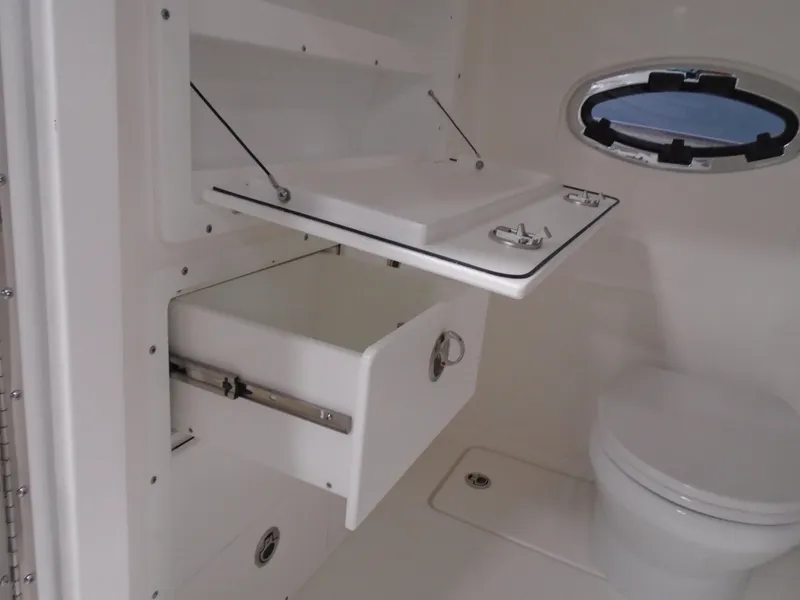Slide: The Image of Interior of 2026 Caymas 34 CT boat featuring storage compartment and toilet. - 36