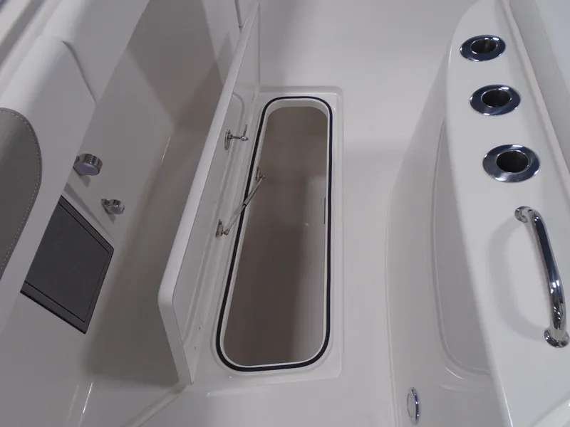 Slide: The Image of 2026 Caymas 34 CT boat interior storage compartment with rod holders and handle. - 38