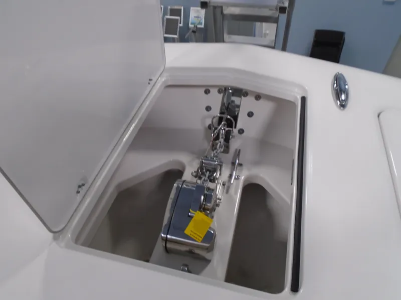 Slide: The Image of 2026 Caymas 34 CT boat anchor compartment with open hatch and chain mechanism. - 42
