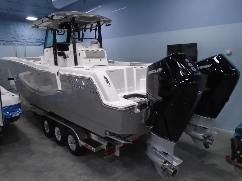 The Image of 2026 Caymas 34 CT boat with dual Mercury engines in showroom. - 6