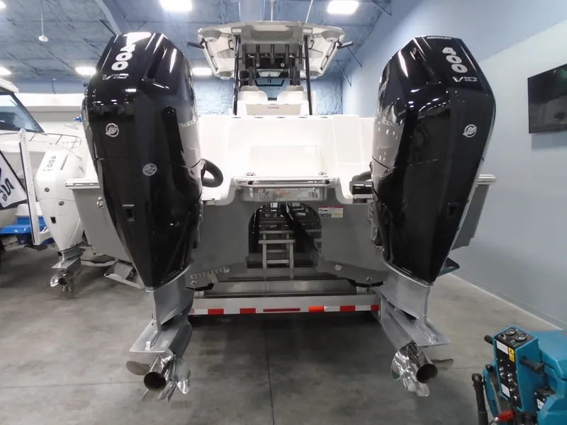 Slide: The Image of 2026 Caymas 34 CT boat with dual 400 V10 outboard engines in a showroom. - 8