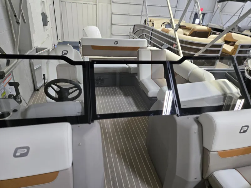 Slide: The Image of 2025 Princecraft Vectra 23 WRL pontoon boat interior with steering wheel and seating. - 1