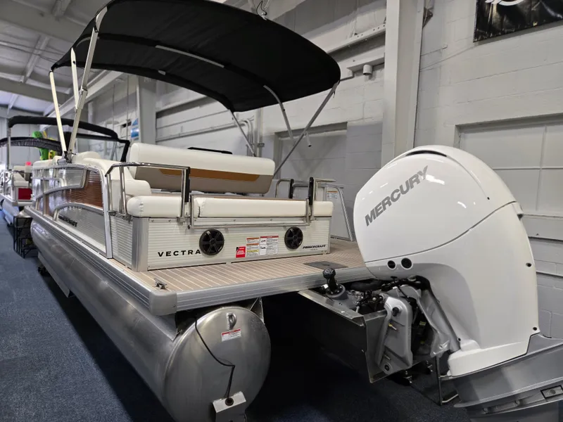 Slide: The Image of 2025 Princecraft Vectra 23 WRL pontoon boat with Mercury outboard motor in showroom. - 25