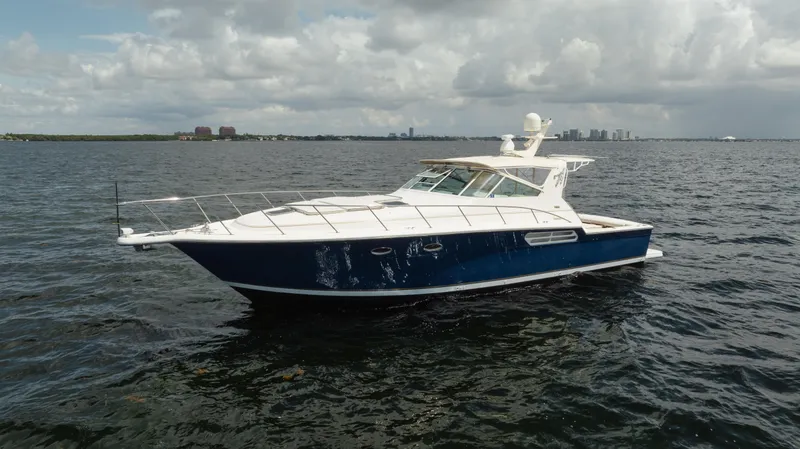 Slide: The Image of 1998 Tiara Yachts 4300 Open cruising on a calm sea under cloudy skies. - 12