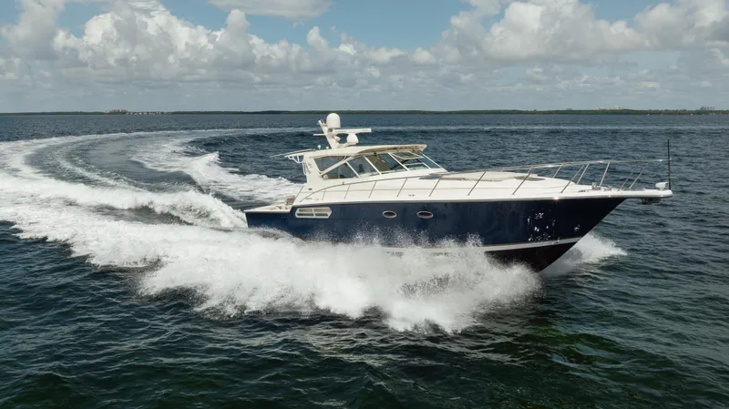 Slide: The Image of 1998 Tiara Yachts 4300 Open cruising on open water under a partly cloudy sky. - 17