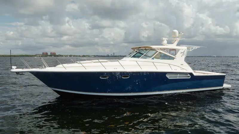 Slide: The Image of 1998 Tiara Yachts 4300 Open cruising on a cloudy day. - 2