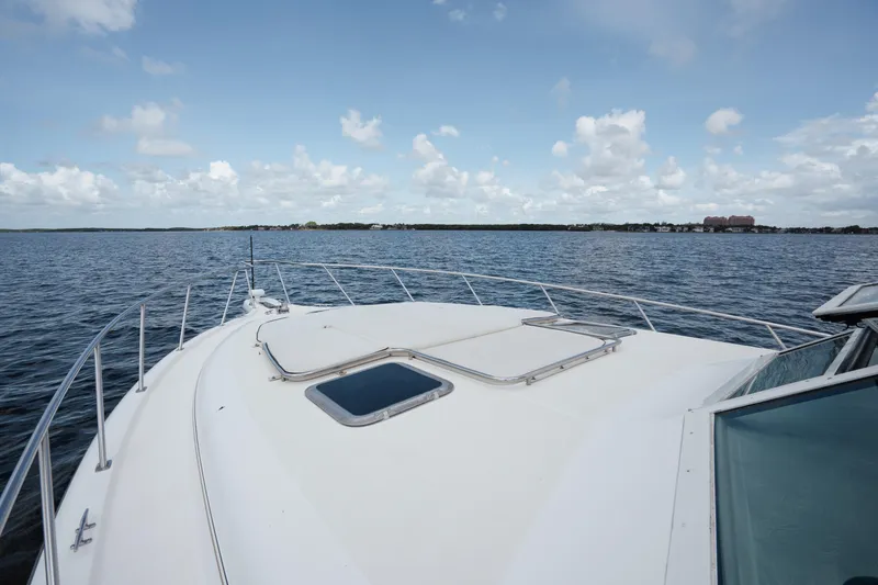 Slide: The Image of 1998 Tiara Yachts 4300 Open on calm water under a partly cloudy sky. - 22