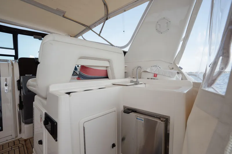 Slide: The Image of 1998 Tiara Yachts 4300 Open interior with seating and kitchenette area. - 24