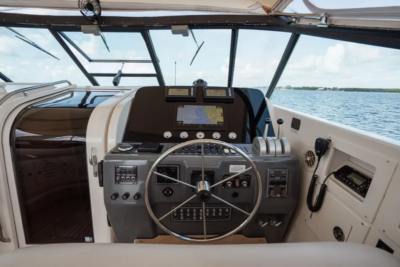 Slide: The Image of Helm of 1998 Tiara Yachts 4300 Open, featuring navigation equipment and steering wheel. - 26