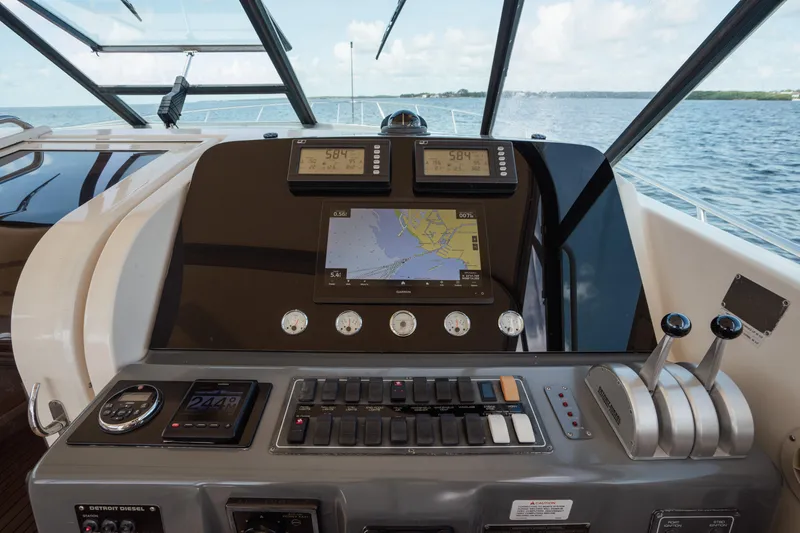 Slide: The Image of Cockpit of 1998 Tiara Yachts 4300 Open with navigation and control systems. - 27