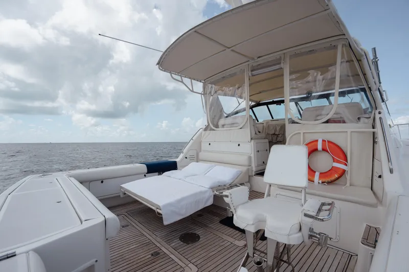 Slide: The Image of 1998 Tiara Yachts 4300 Open deck with seating, life preserver, and ocean view. - 28