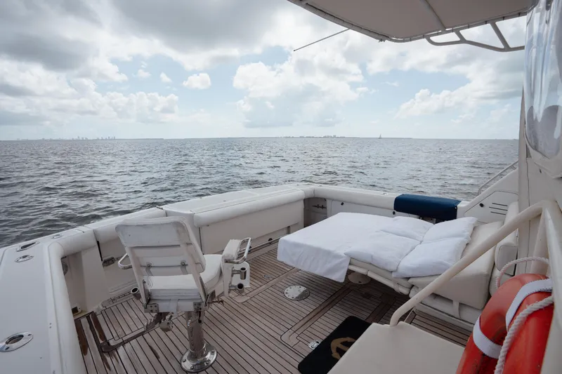 Slide: The Image of 1998 Tiara Yachts 4300 Open deck with seating, ocean view, and cloudy sky. - 32