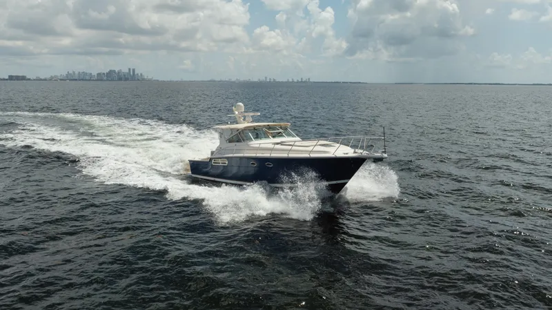 Slide: The Image of 1998 Tiara Yachts 4300 Open cruising on open water under cloudy skies. - 5