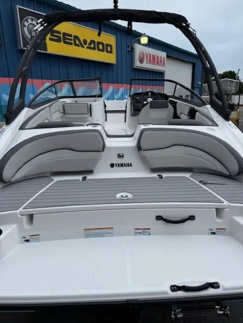 Slide: The Image of 2025 Yamaha Boats AR190, sleek design, spacious seating, displayed at dealership. - 2