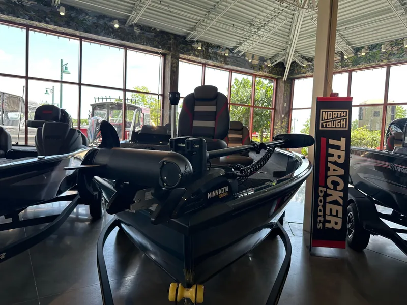Slide: The Image of 2025 Ranger VS1882SC Reata boat displayed in showroom with Minn Kota motor. - 0