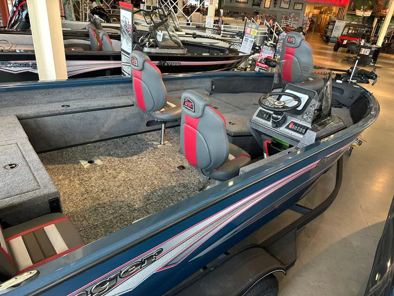 Slide: The Image of 2025 Ranger VS1882SC Reata boat interior with seating and control panel in showroom. - 2