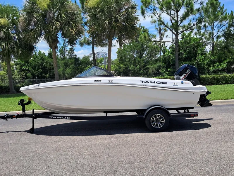 The Image of 2025 Tahoe 200 S boat on trailer, parked near palm trees. - 0