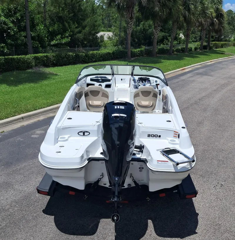 Slide: The Image of 2025 Tahoe 200 S boat with outboard motor, parked on a sunny day. - 4