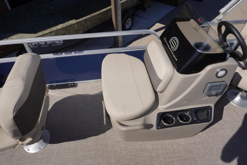 Slide: The Image of 2025 Sun Tracker Bass Buggy 16 XL Select boat interior with beige seating and console. - 10