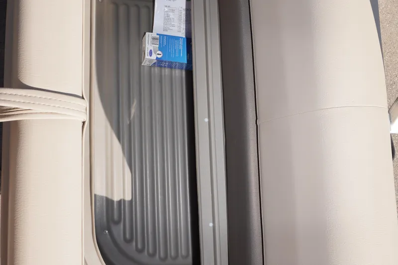 Slide: The Image of 2025 Sun Tracker Bass Buggy 16 XL Select interior storage compartment with beige seating. - 12