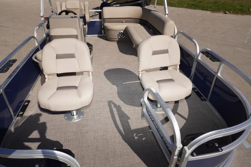 Slide: The Image of 2025 Sun Tracker Bass Buggy 16 XL Select pontoon boat interior with beige seating. - 7