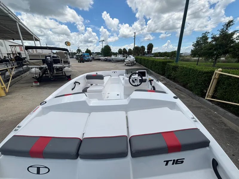Slide: The Image of 2025 Tahoe T16 boat with sleek design, docked under a partly cloudy sky. - 3