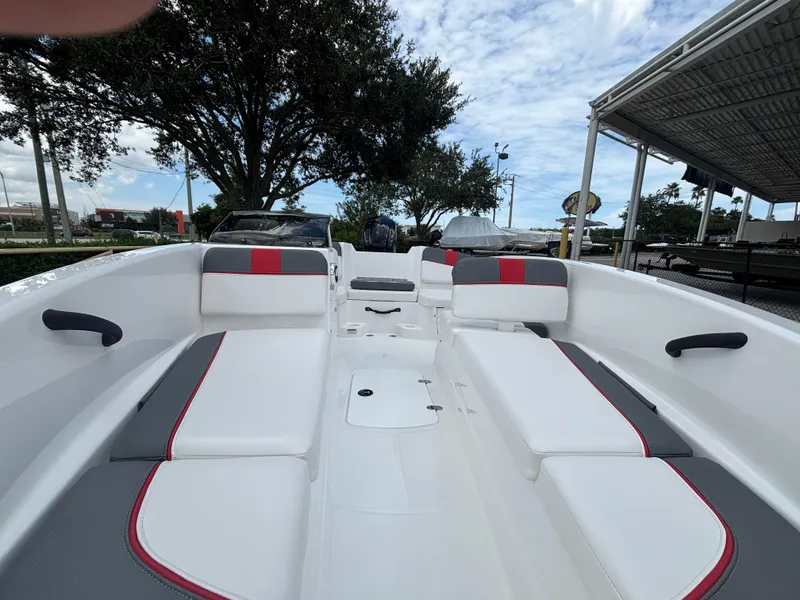 Slide: The Image of 2025 Tahoe T16 boat interior with white and red seating, under a partly cloudy sky. - 4