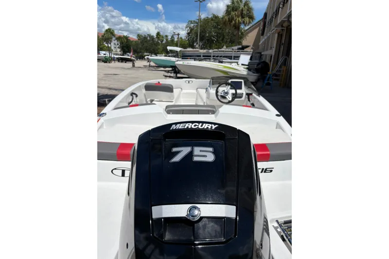 Slide: The Image of 2025 Tahoe T16 boat with Mercury 75 engine, docked outdoors under a clear sky. - 4