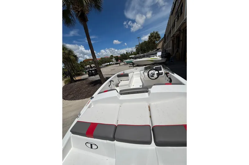 Slide: The Image of 2025 Tahoe T16 boat with sleek design, parked outdoors under a clear blue sky. - 8