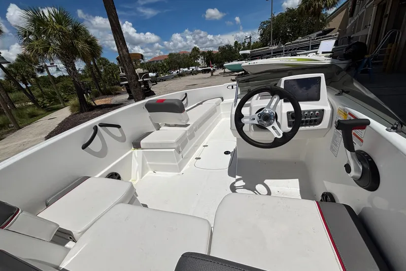 Slide: The Image of 2025 Tahoe T16 boat interior with steering wheel and seating under a sunny sky. - 6