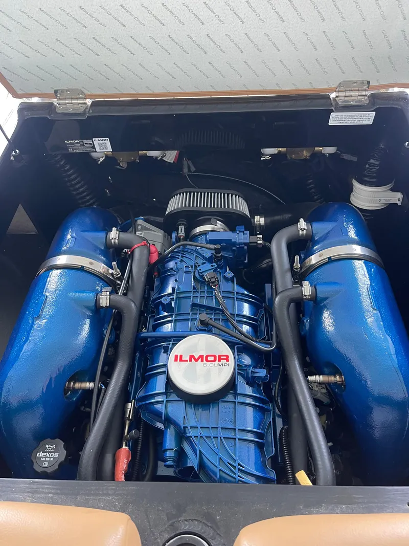 Slide: The Image of Engine of 2020 MasterCraft XT23 boat with Ilmor branding, featuring blue components. - 8