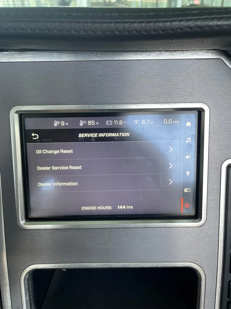 Slide: The Image of 2020 MasterCraft XT23 dashboard displaying service information and engine hours. - 9